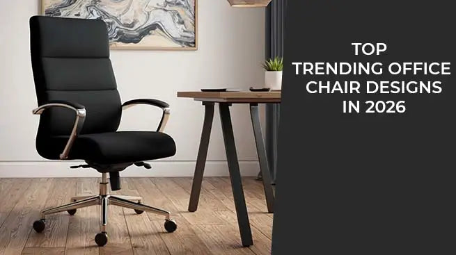 A high-back black ergonomic leather office chair with chrome accents situated next to a minimalist wooden desk in a modern home office.